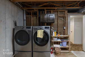 Laundry area with separate washer and dryer and cabinet space