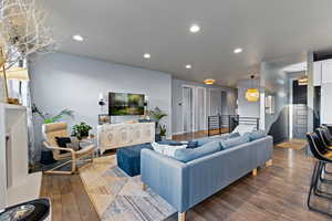 Living area with wood-type flooring and recessed lighting