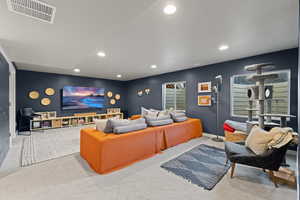 Living area with recessed lighting and carpet