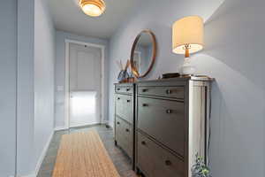 Hallway featuring baseboards and light wood finished floors