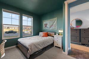Bedroom featuring carpet floors and baseboards