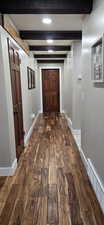 Hallway featuring dark wood-type flooring, beamed ceiling, and recessed lighting