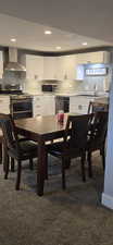 Dining room featuring dark colored carpet and recessed lighting