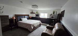 Bedroom with carpet floors and a textured ceiling