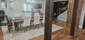 Dining area with wood finished floors and suspended lighting