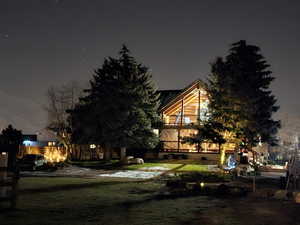 Back of house at twilight with a yard