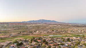Aerial view at dusk of view of golf course, a residential view, and a mountain view