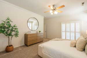 Bedroom with crown molding, carpet flooring, and ceiling fan