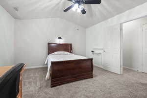 Bedroom with lofted ceiling, carpet flooring, and ceiling fan