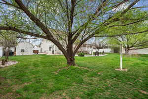Fenced yard featuring a storage shed and a patio area