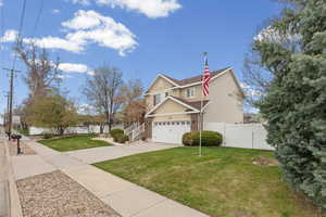 Traditional home featuring brick siding and driveway