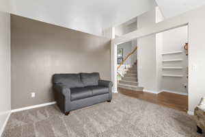 Living area with carpet and stairs