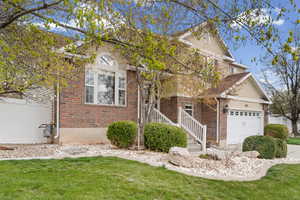 View of front of home featuring a garage, brick siding, and concrete driveway