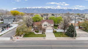View of front of house with concrete driveway, a residential view, and a mountain view