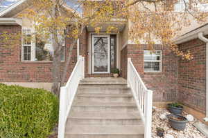 Property entrance featuring brick siding