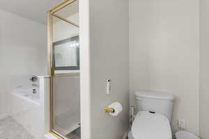 Full bath with a marble finish shower and a bath