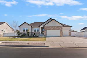Craftsman inspired home featuring board and batten siding, a gate, a garage, concrete driveway, and brick siding
