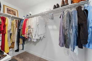 Walk in closet with carpet flooring