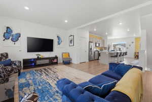 Living room featuring light wood-style flooring and recessed lighting
