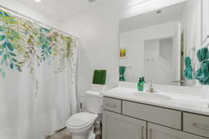 Bathroom featuring vanity and curtained shower