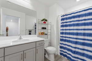 Full bath featuring vanity, light wood finished floors, shower / tub combo, and recessed lighting
