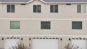 View of an attached garage, and stucco siding