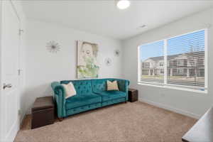 Living room with carpet flooring and baseboards