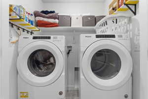 Laundry area with washing machine and clothes dryer