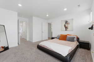 Bedroom featuring light colored carpet and recessed lighting