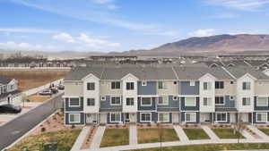 Aerial view of residential area featuring a mountainous background