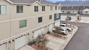 View of attached garage, concrete driveway, and a mountain view