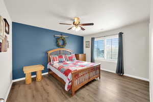 Bedroom with wood finished floors and ceiling fan