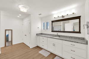 Bathroom featuring vanity, a shower with shower curtain, light wood-type flooring, and recessed lighting