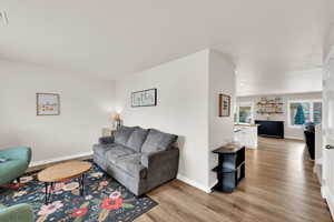 Living room with light wood-style flooring and baseboards