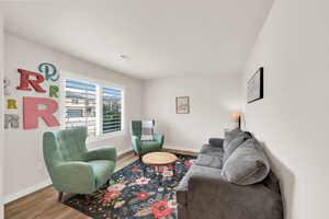 Living area with light wood-type flooring and baseboards