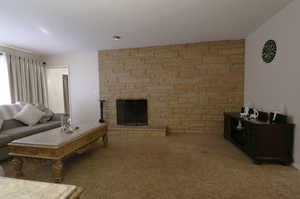 Carpeted living room featuring a fireplace