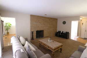 Living area featuring a fireplace and carpet flooring