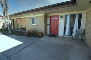 Entrance to property featuring brick siding