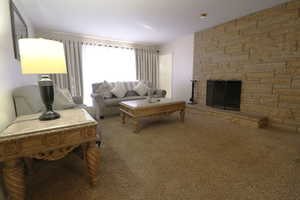 Living room featuring a fireplace and carpet floors