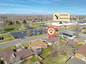 Aerial view of property and surrounding area with nearby suburban area