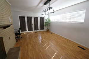 Unfurnished office with light wood-type flooring and baseboards