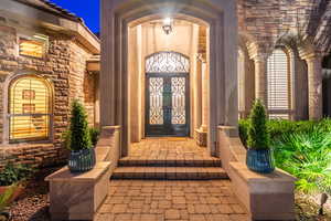 Property entrance featuring stone siding and french doors