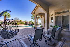 Fenced backyard with a patio, an outdoor pool, and an in-ground hot tub