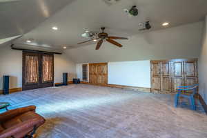 Unfurnished living room with vaulted ceiling, carpet, recessed lighting, and a ceiling fan