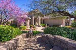 View of front of house featuring stone siding and stucco siding