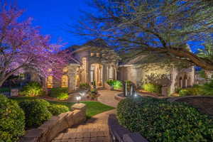 View of front of home featuring stucco siding and stone siding