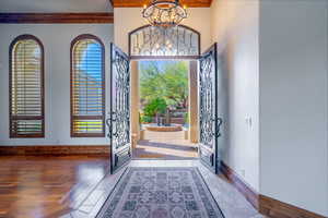 Foyer with a chandelier and baseboards