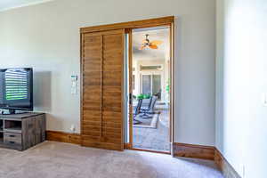 Doorway to outside with carpet and ceiling fan