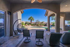 View of patio / terrace featuring a pool with connected hot tub and a residential view
