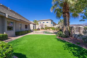 Fenced backyard with a pool with connected hot tub
